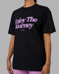 Woman wearing Unisex Enjoy The Journey FLXCotton Tee Oversize - Black-Light Violet