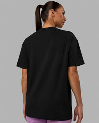 Woman wearing Unisex Enjoy The Journey FLXCotton Tee Oversize - Black-Light Violet