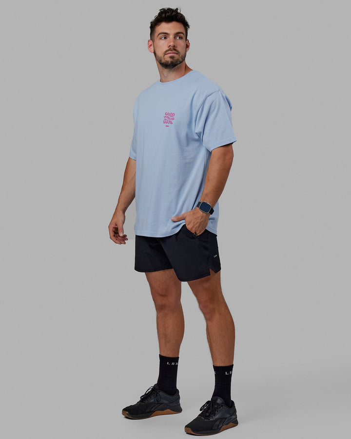 Man wearing Unisex Good Times Heavyweight Tee Oversize - Windsurfer-Spark Pink