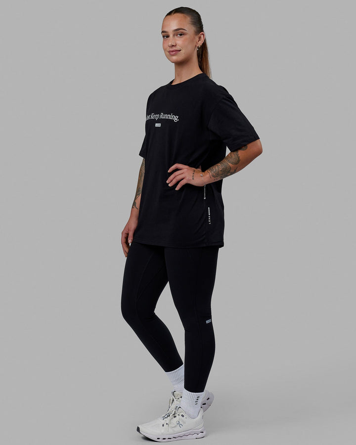 Woman wearing Unisex Just Keep Running FLXCotton Tee Oversize - Black-White