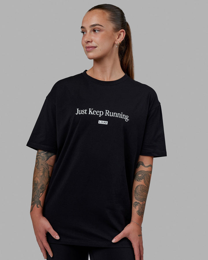 Woman wearing Unisex Just Keep Running FLXCotton Tee Oversize - Black-White