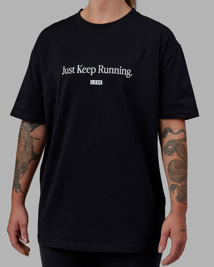 Woman wearing Unisex Just Keep Running FLXCotton Tee Oversize - Black-White