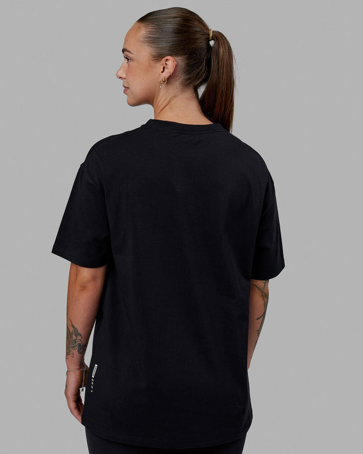Woman wearing Unisex Just Keep Running FLXCotton Tee Oversize - Black-White
