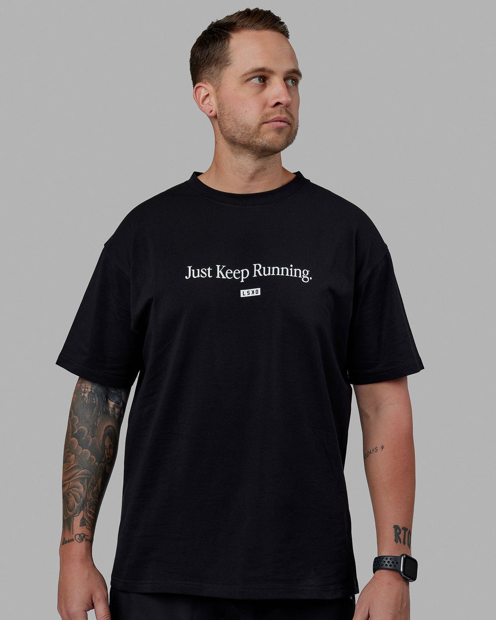 Man wearing Unisex Just Keep Running FLXCotton Tee Oversize - Black-White