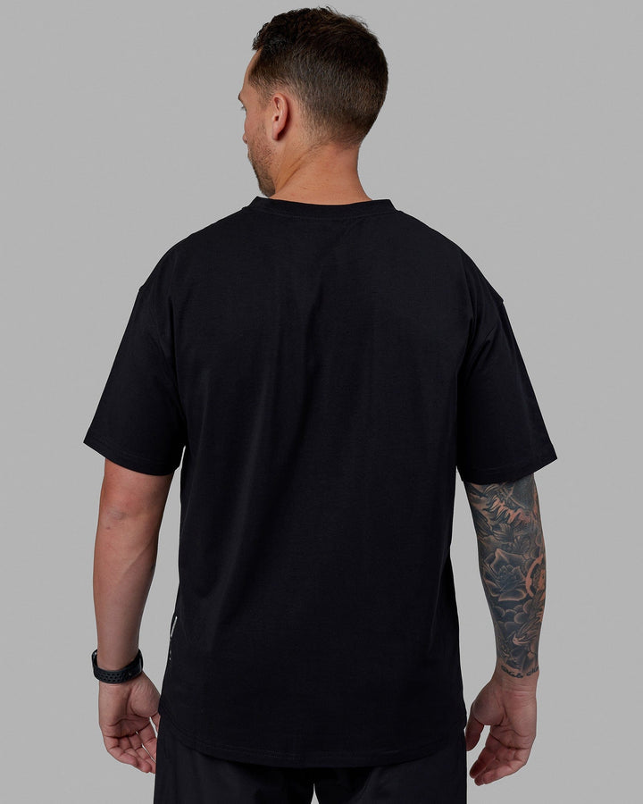 Man wearing Unisex Just Keep Running FLXCotton Tee Oversize - Black-White