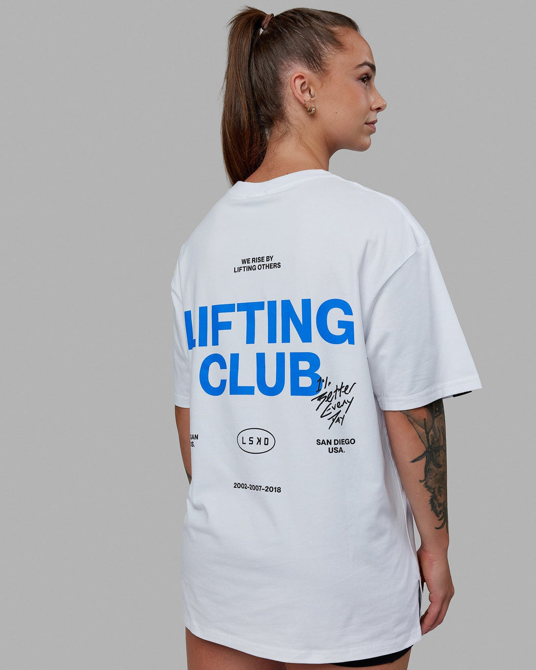 Woman wearing Lifting Club FLXCotton Tee Oversize - White-Power Cobalt-Black