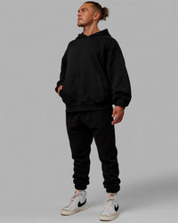 Man wearing Unisex Love The Run Hoodie Oversize - Black-White