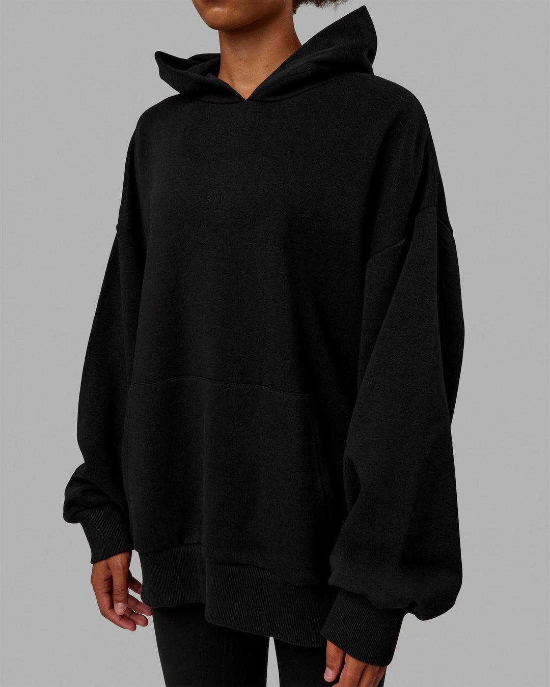 Woman wearing Unisex MVP Hoodie Oversize - Black