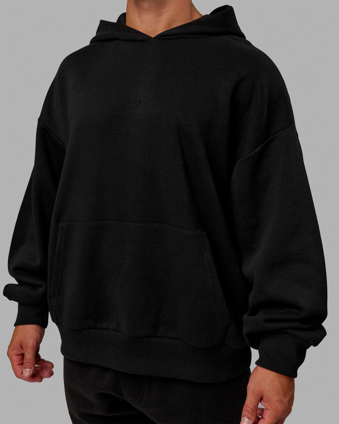 Man wearing Unisex MVP Hoodie Oversize - Black