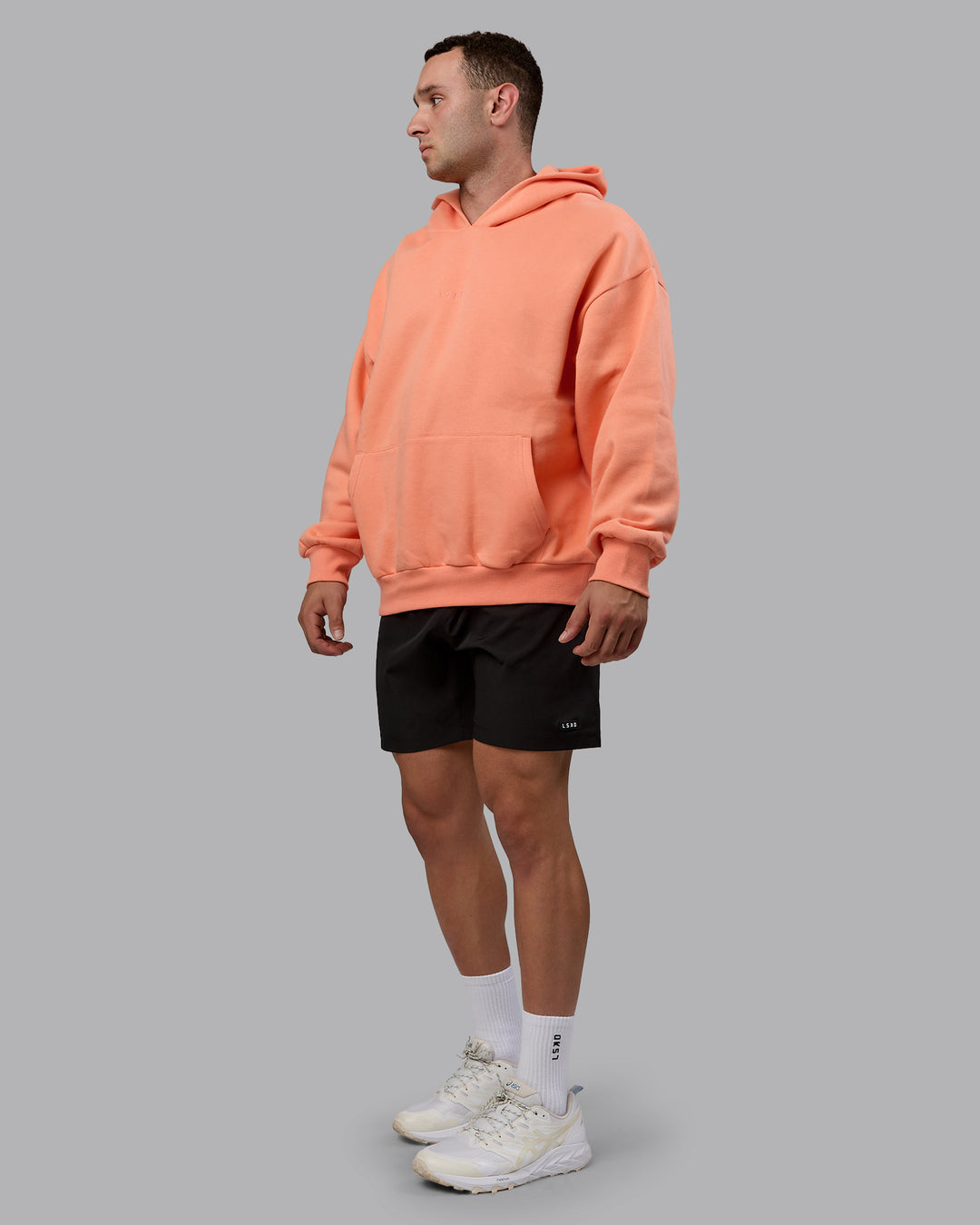 Man wearing Unisex MVP Hoodie Oversize - Mellow Peach