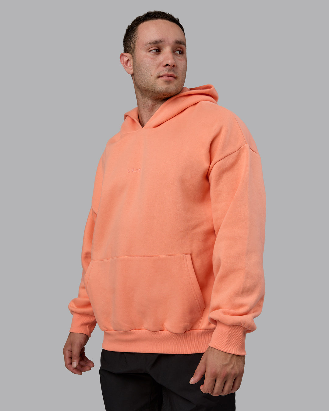 Man wearing Unisex MVP Hoodie Oversize - Mellow Peach
