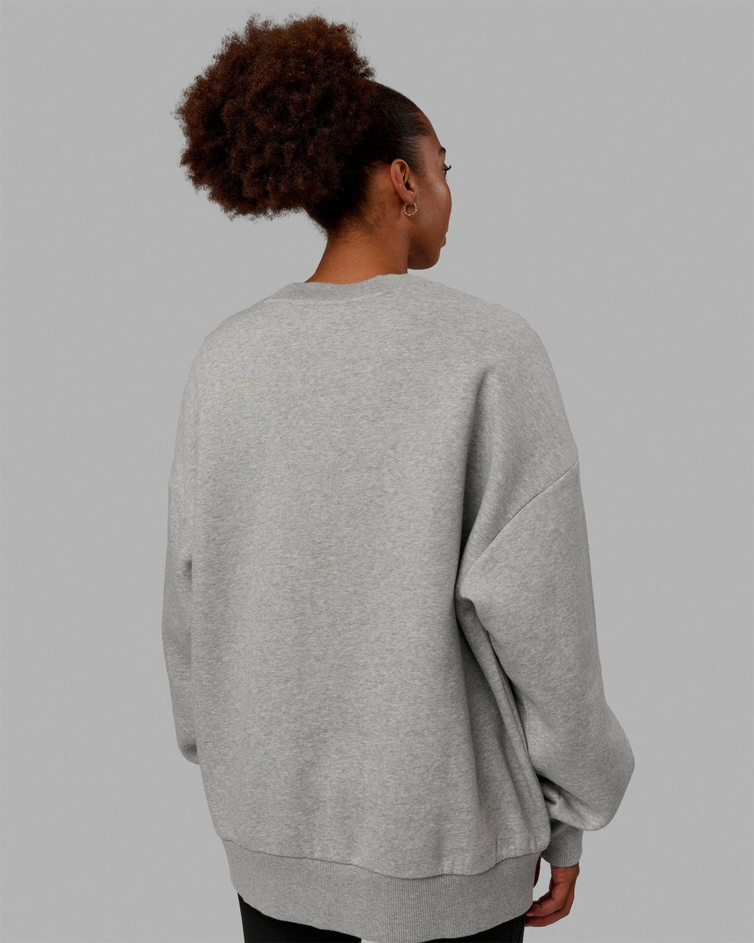Woman wearing Unisex MVP Sweater Oversize - Lt Grey Marl