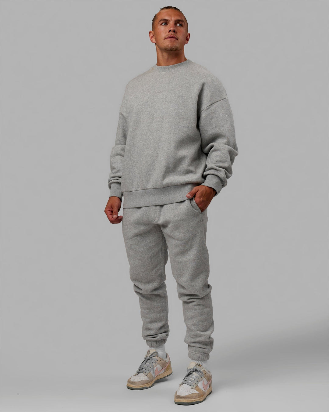 Man wearing Unisex MVP Sweater Oversize - Lt Grey Marl
