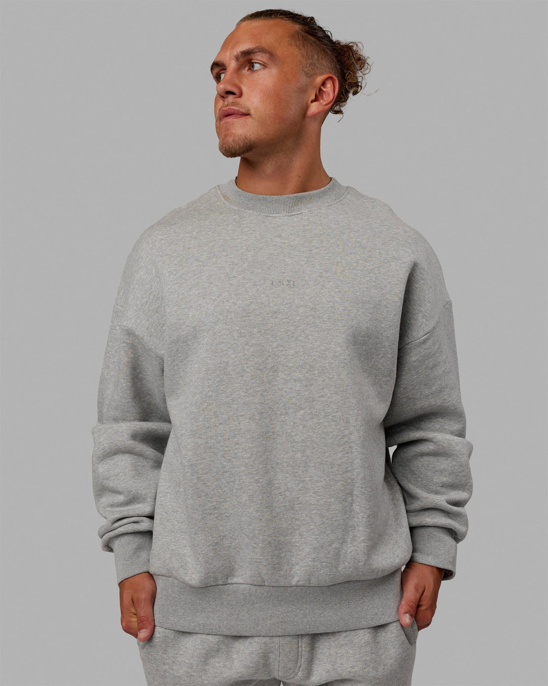 Man wearing Unisex MVP Sweater Oversize - Lt Grey Marl