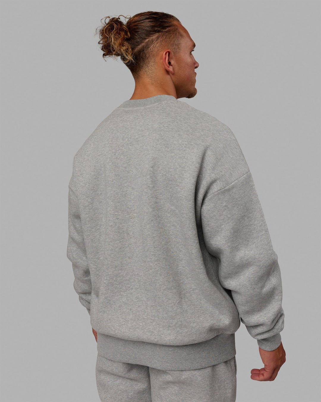 Man wearing Unisex MVP Sweater Oversize - Lt Grey Marl