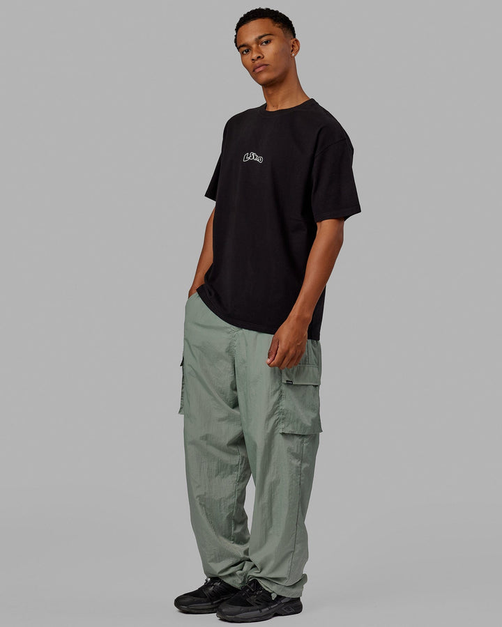 Man wearing Unisex Mad Happy Heavyweight Tee Oversize - Black