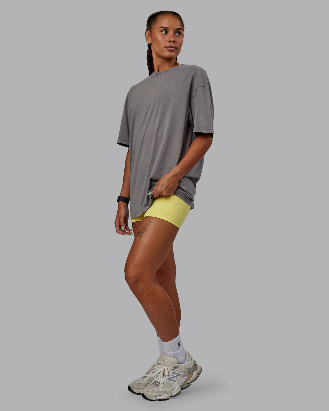 Woman wearing Unisex Miami25 Washed FLXCotton Tee Oversize - Storm Front-Lemon Fizz