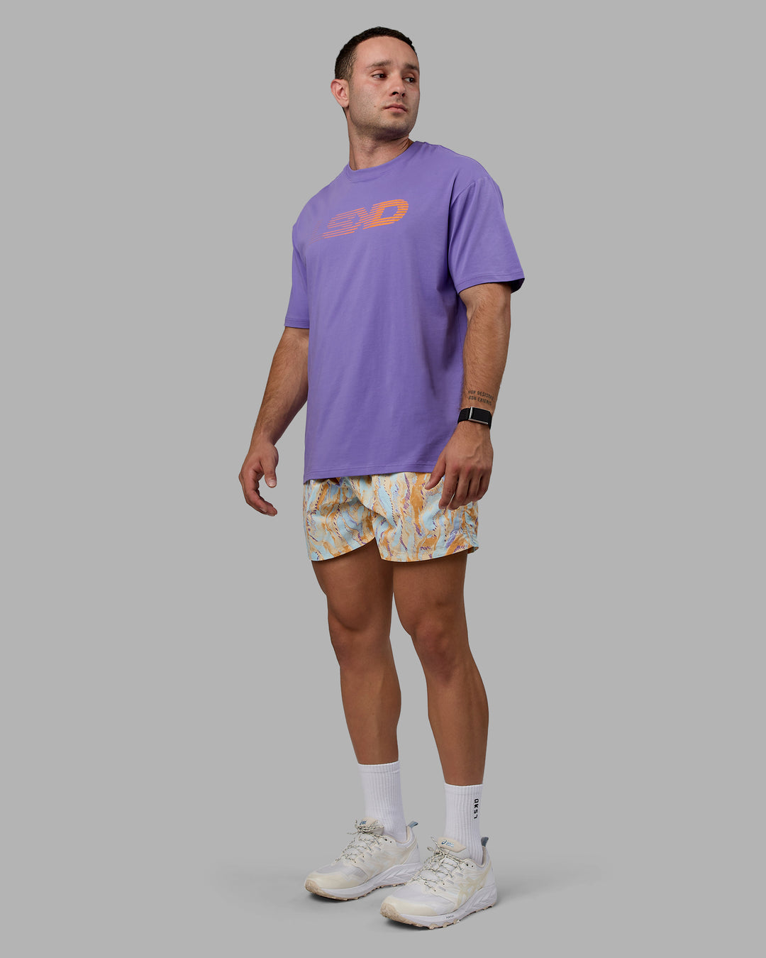 Man wearing Unisex Motion FLXCotton Tee Oversize - Dahlia Purple-Vibrant Orange