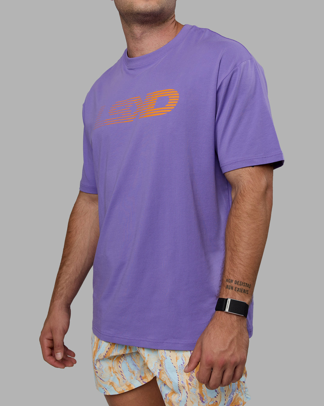 Man wearing Unisex Motion FLXCotton Tee Oversize - Dahlia Purple-Vibrant Orange