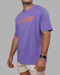 Man wearing Unisex Motion FLXCotton Tee Oversize - Dahlia Purple-Vibrant Orange