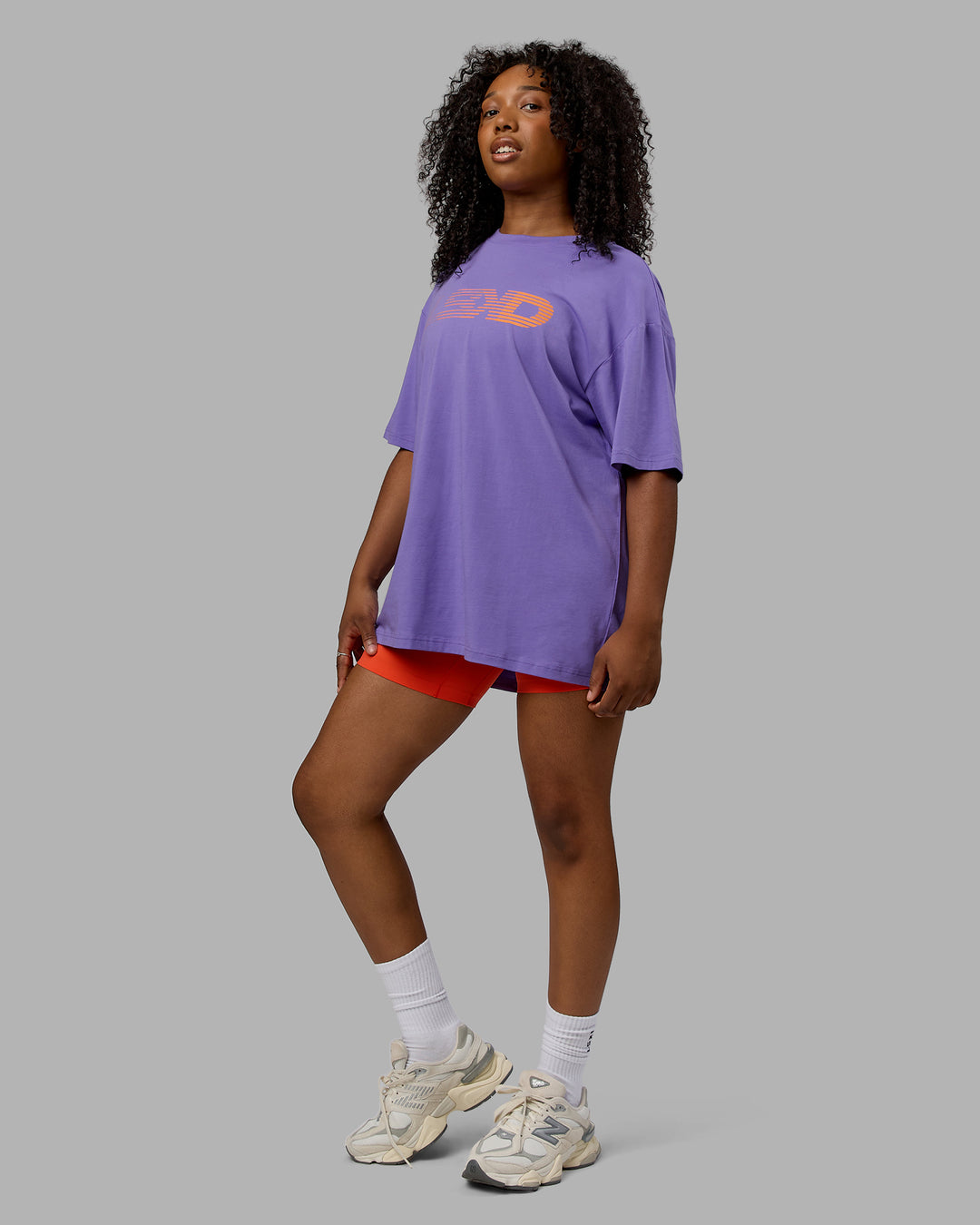 Woman wearing Unisex Motion FLXCotton Tee Oversize - Dahlia Purple-Vibrant Orange
