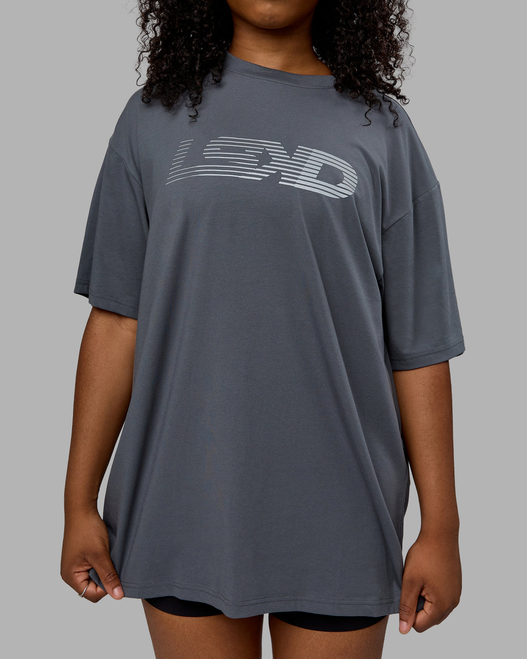 Woman wearing Unisex Motion FLXCotton Tee Oversize - Turbulence-Metallic Silver