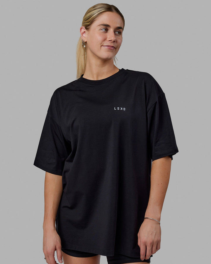 Woman wearing Unisex PimaFLX Tee Oversize - Black