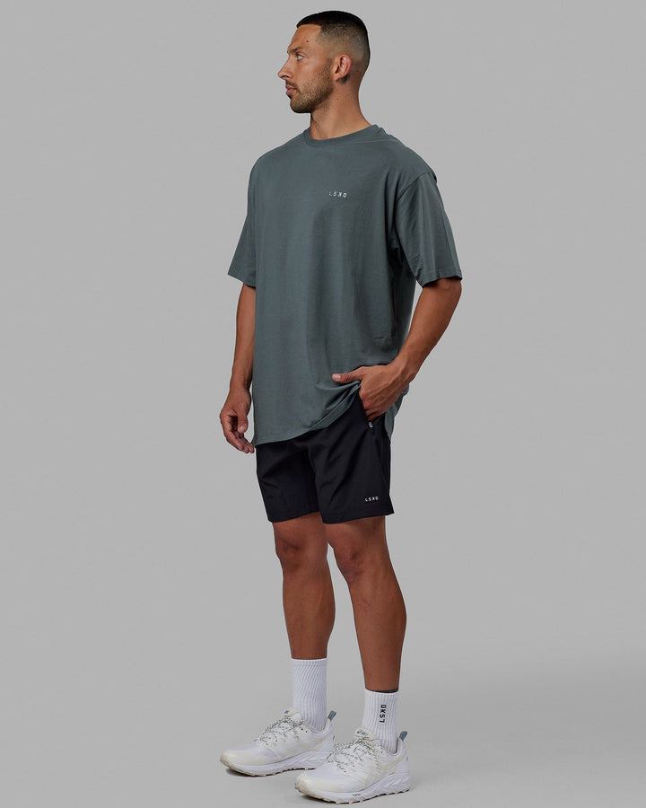 Man wearing Unisex PimaFLX Tee Oversize - Storm