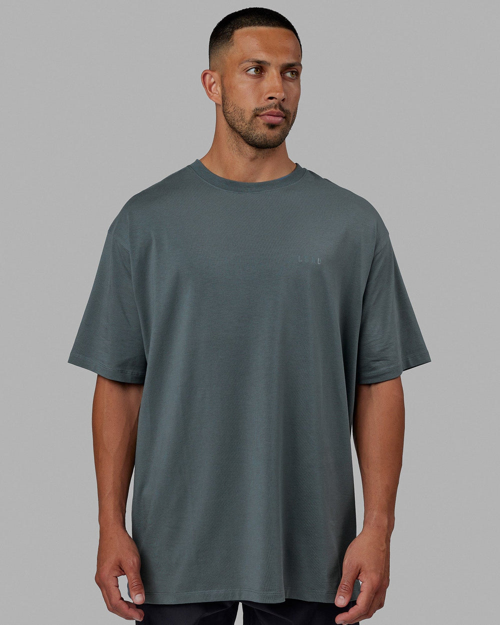 Man wearing Unisex PimaFLX Tee Oversize - Storm
