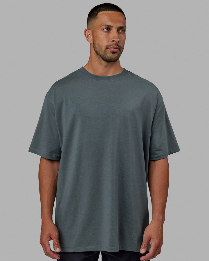 Man wearing Unisex PimaFLX Tee Oversize - Storm