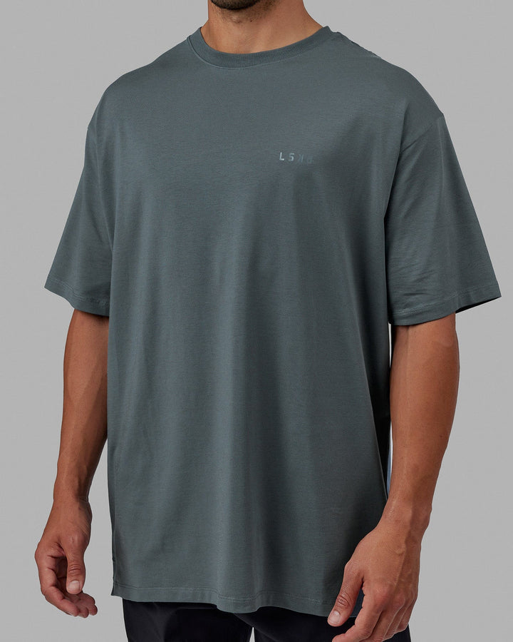 Man wearing Unisex PimaFLX Tee Oversize - Storm