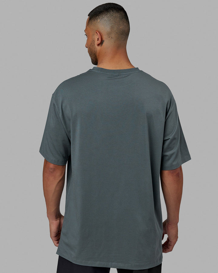 Man wearing Unisex PimaFLX Tee Oversize - Storm