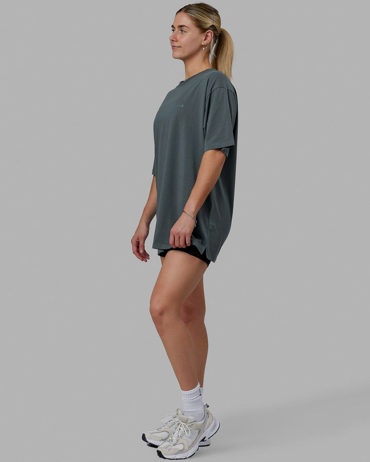Woman wearing Unisex PimaFLX Tee Oversize - Storm