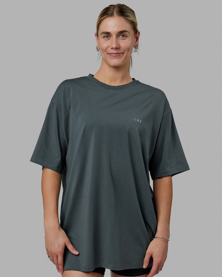 Woman wearing Unisex PimaFLX Tee Oversize - Storm