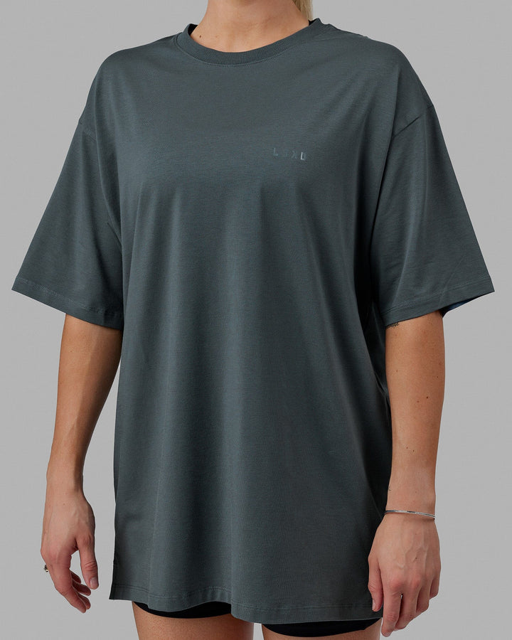 Woman wearing Unisex PimaFLX Tee Oversize - Storm