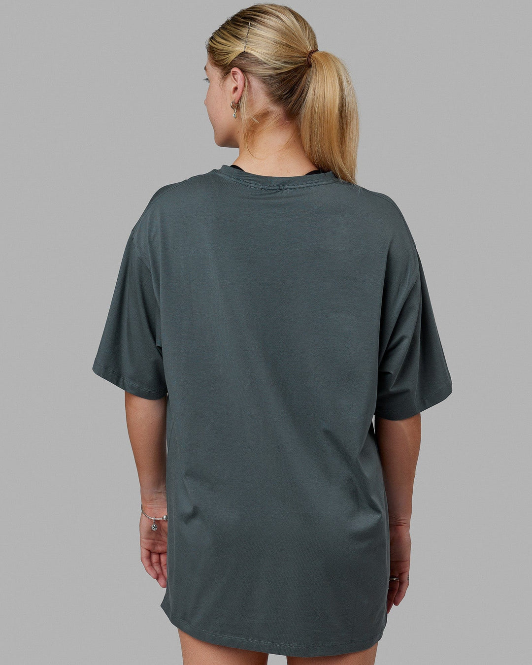 Woman wearing Unisex PimaFLX Tee Oversize - Storm