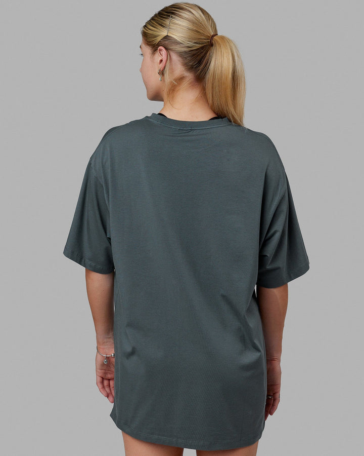Woman wearing Unisex PimaFLX Tee Oversize - Storm