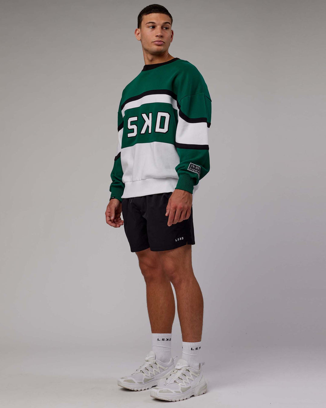 Man wearing Unisex PrimeTime Sweater Oversize - Malachite-White