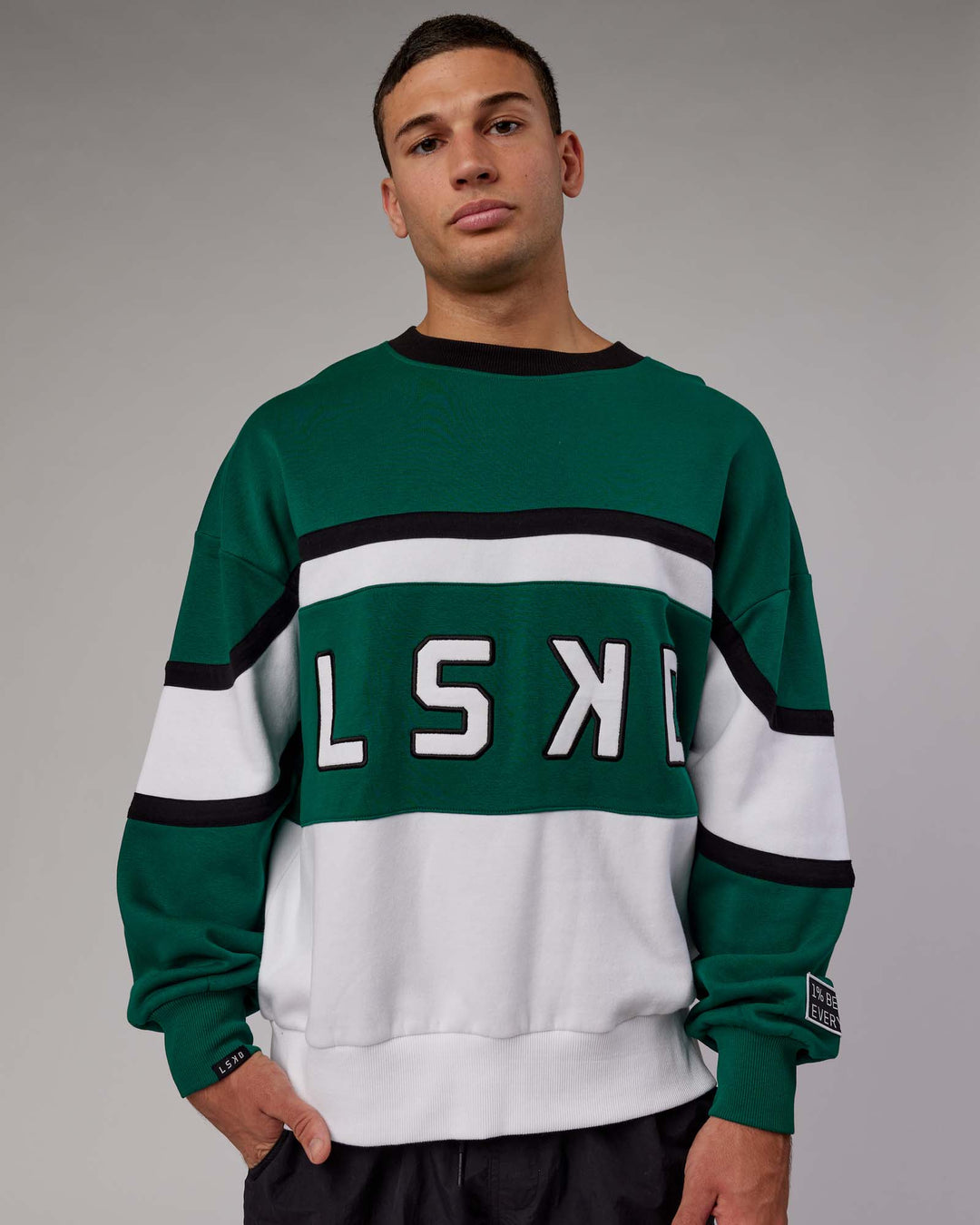 Man wearing Unisex PrimeTime Sweater Oversize - Malachite-White
