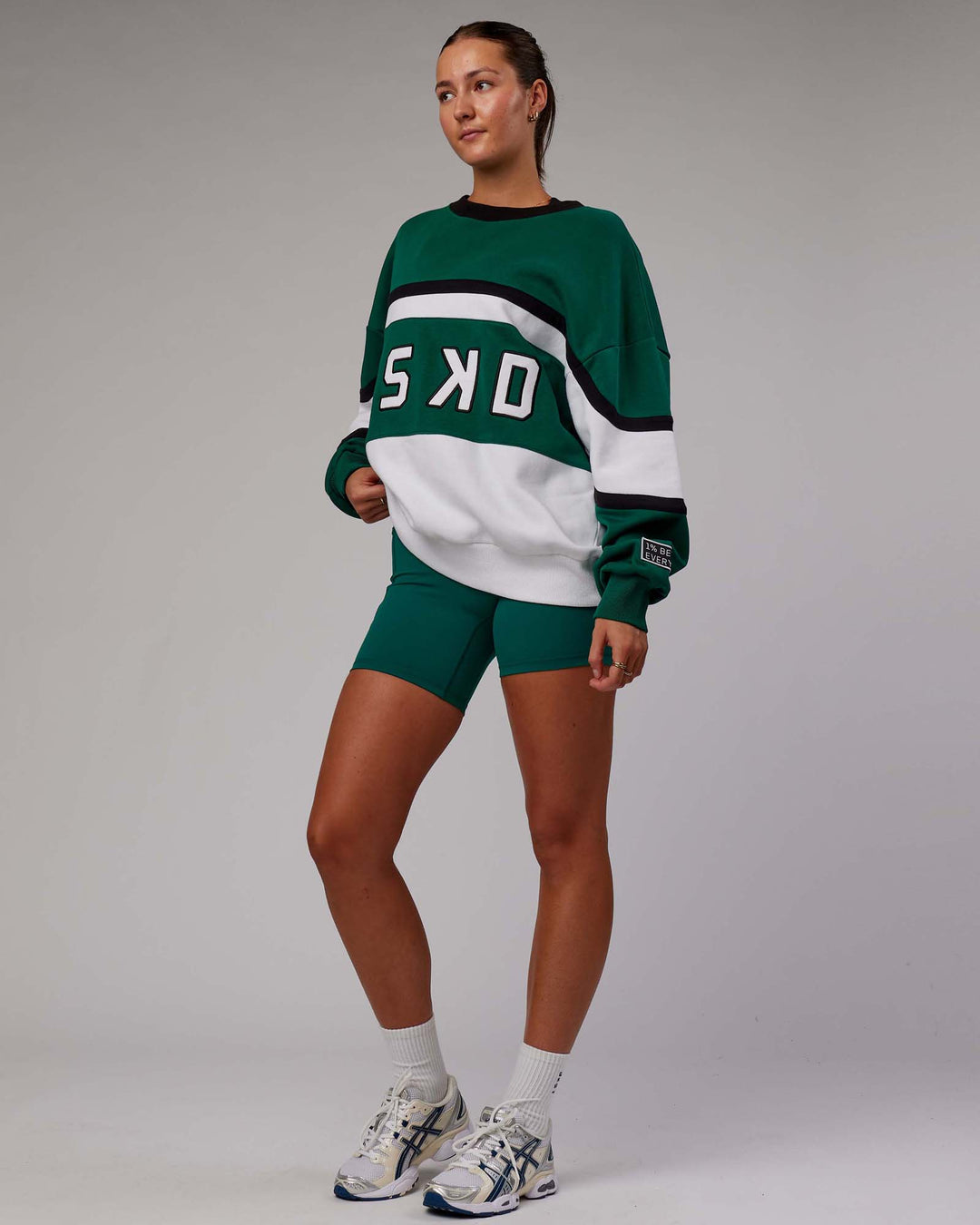 Woman wearing Unisex PrimeTime Sweater Oversize - Malachite-White