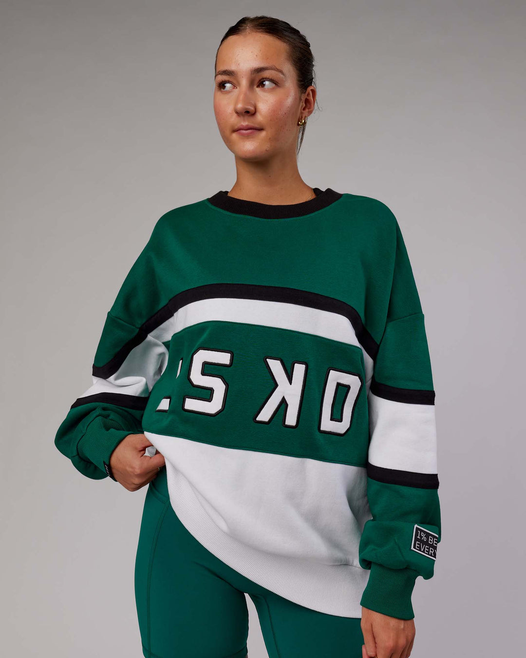 Woman wearing Unisex PrimeTime Sweater Oversize - Malachite-White