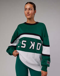 Woman wearing Unisex PrimeTime Sweater Oversize - Malachite-White
