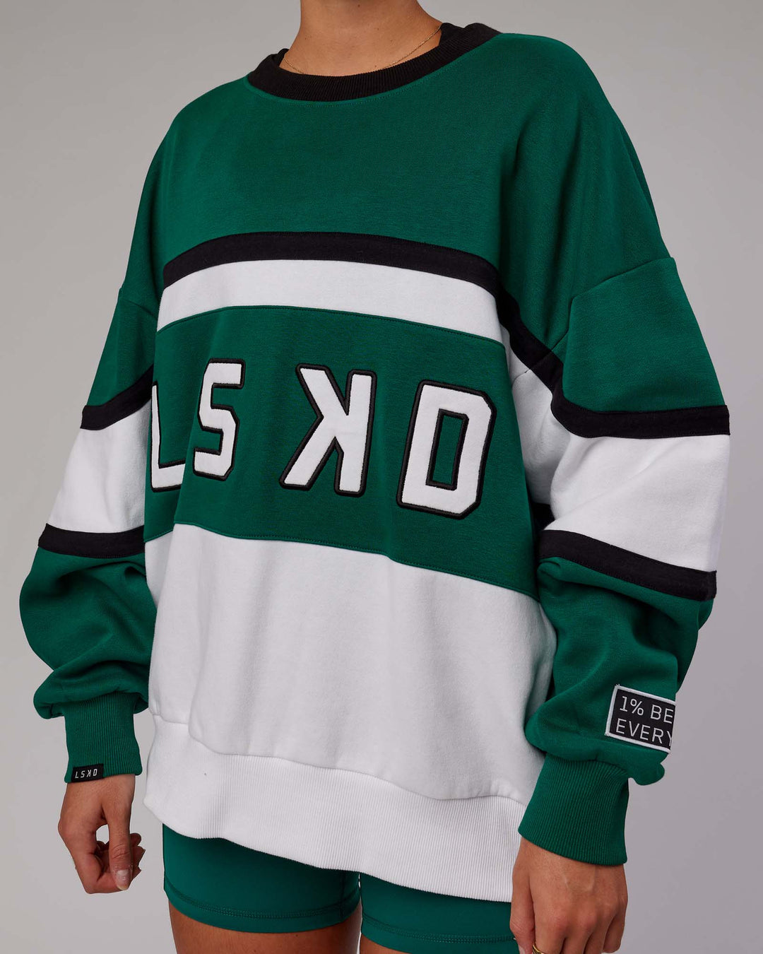 Woman wearing Unisex PrimeTime Sweater Oversize - Malachite-White