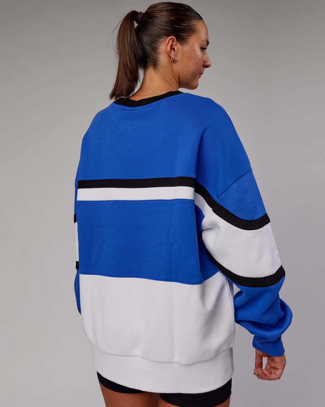 Woman wearing Unisex PrimeTime Sweater Oversize - Power Cobalt-White