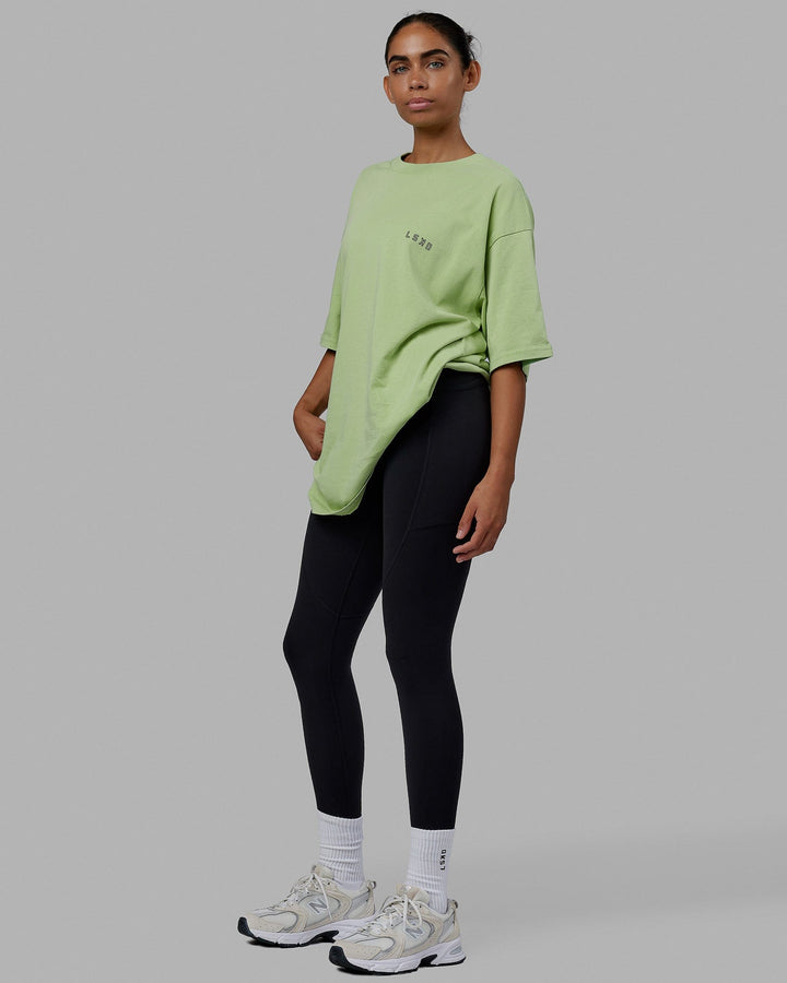 Woman wearing Unisex Rise & Lift Heavyweight Tee Oversize - Washed Green Fig