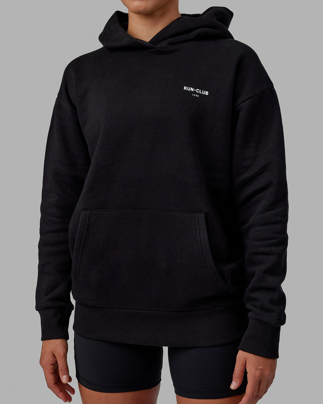 Woman wearing Unisex RUN-CLUB Hoodie Oversize - Black