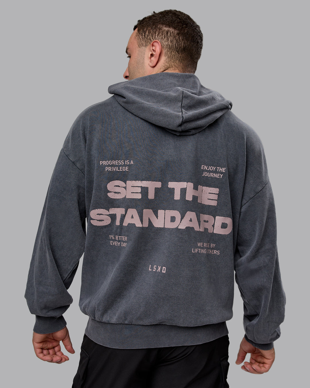 Man wearing Unisex Washed Set the Standard Hoodie Oversize - Black-Greyish Purple