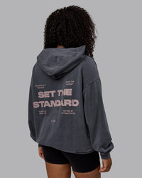 Woman wearing Unisex Washed Set the Standard Hoodie Oversize - Black-Greyish Purple