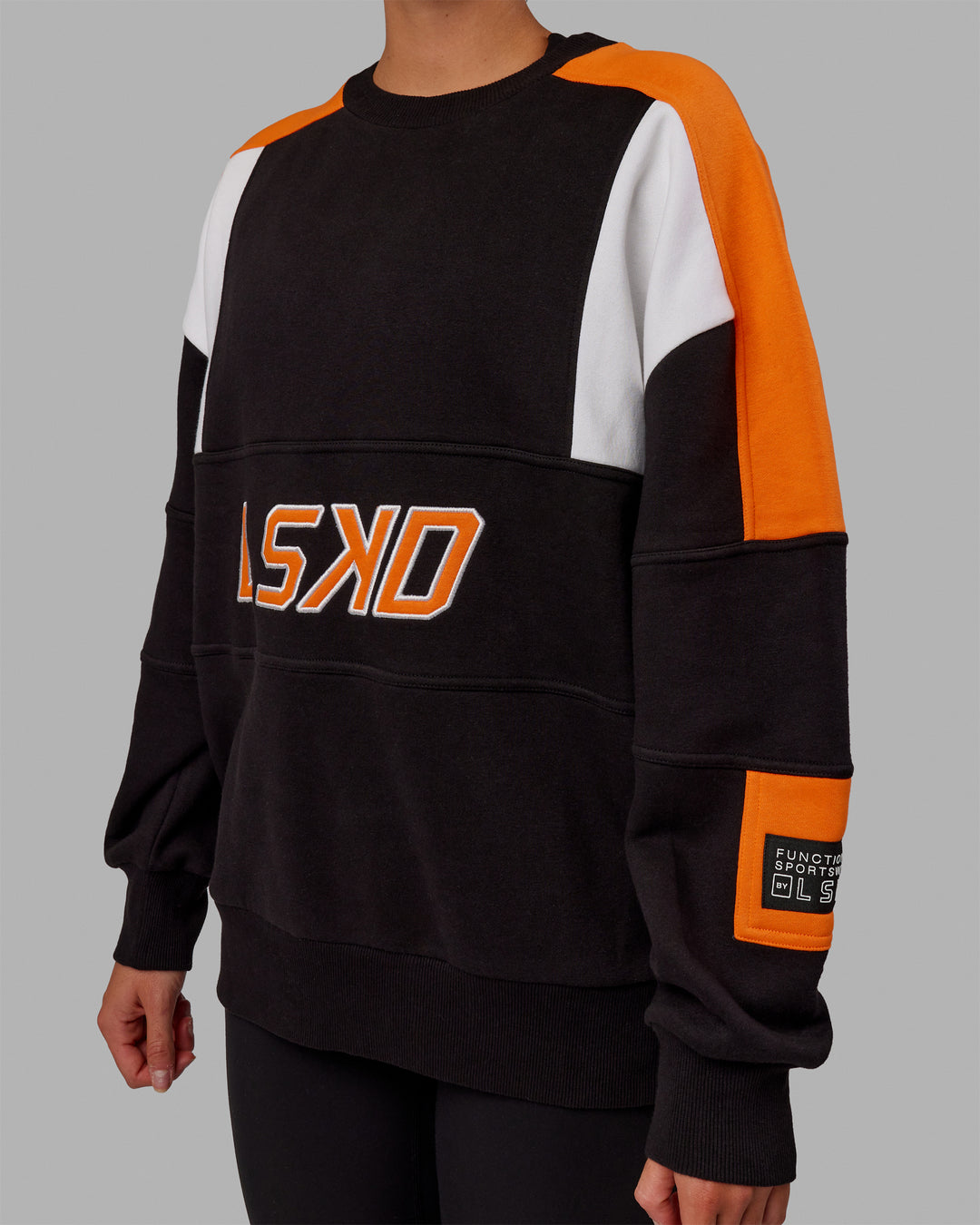 Woman wearing Unisex Slam Sweater Oversize - Black-Ultra Orange