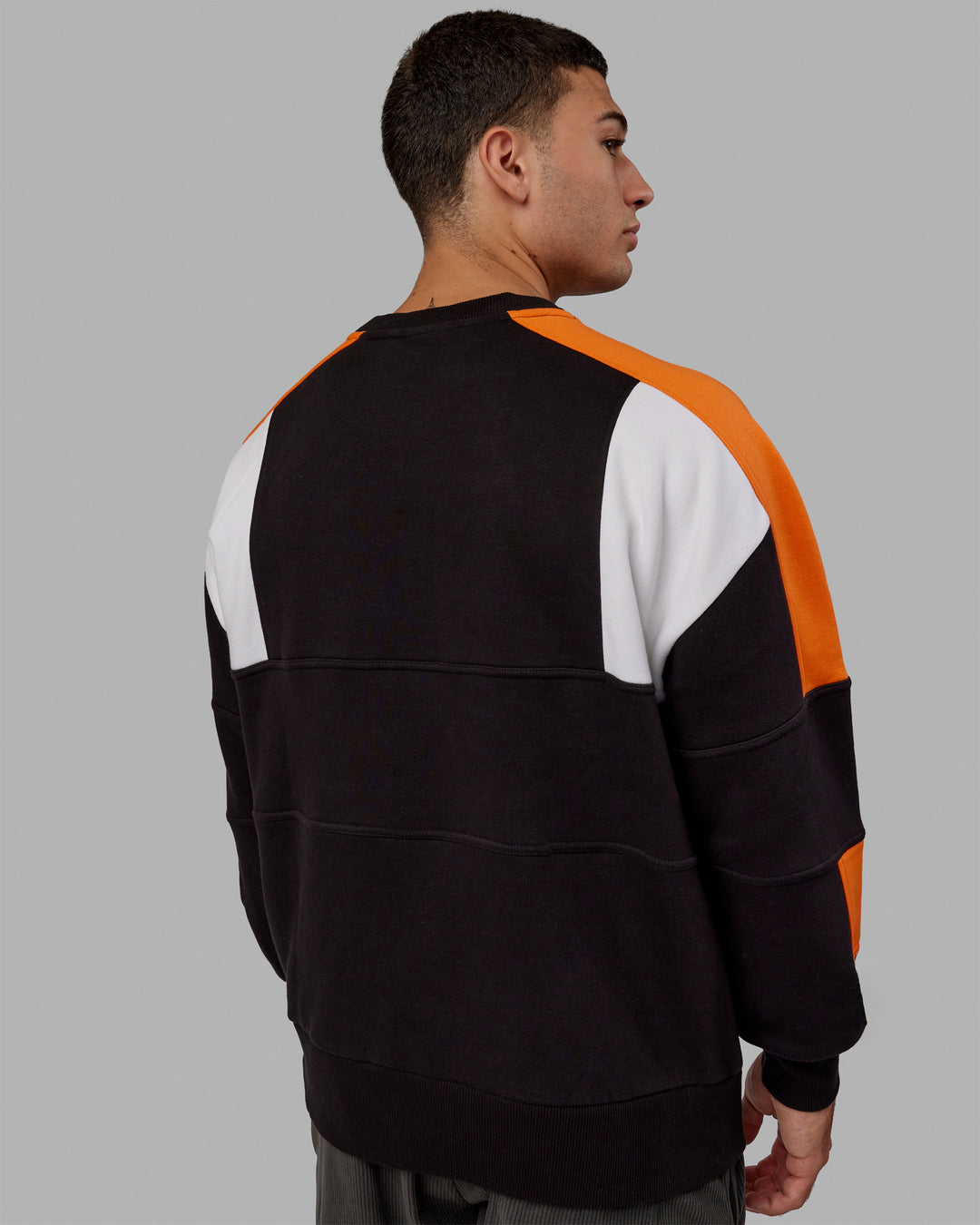 Man wearing Unisex Slam Sweater Oversize - Black-Ultra Orange